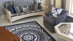 Una sala de estar con sofá, sillón y mesa de centro.