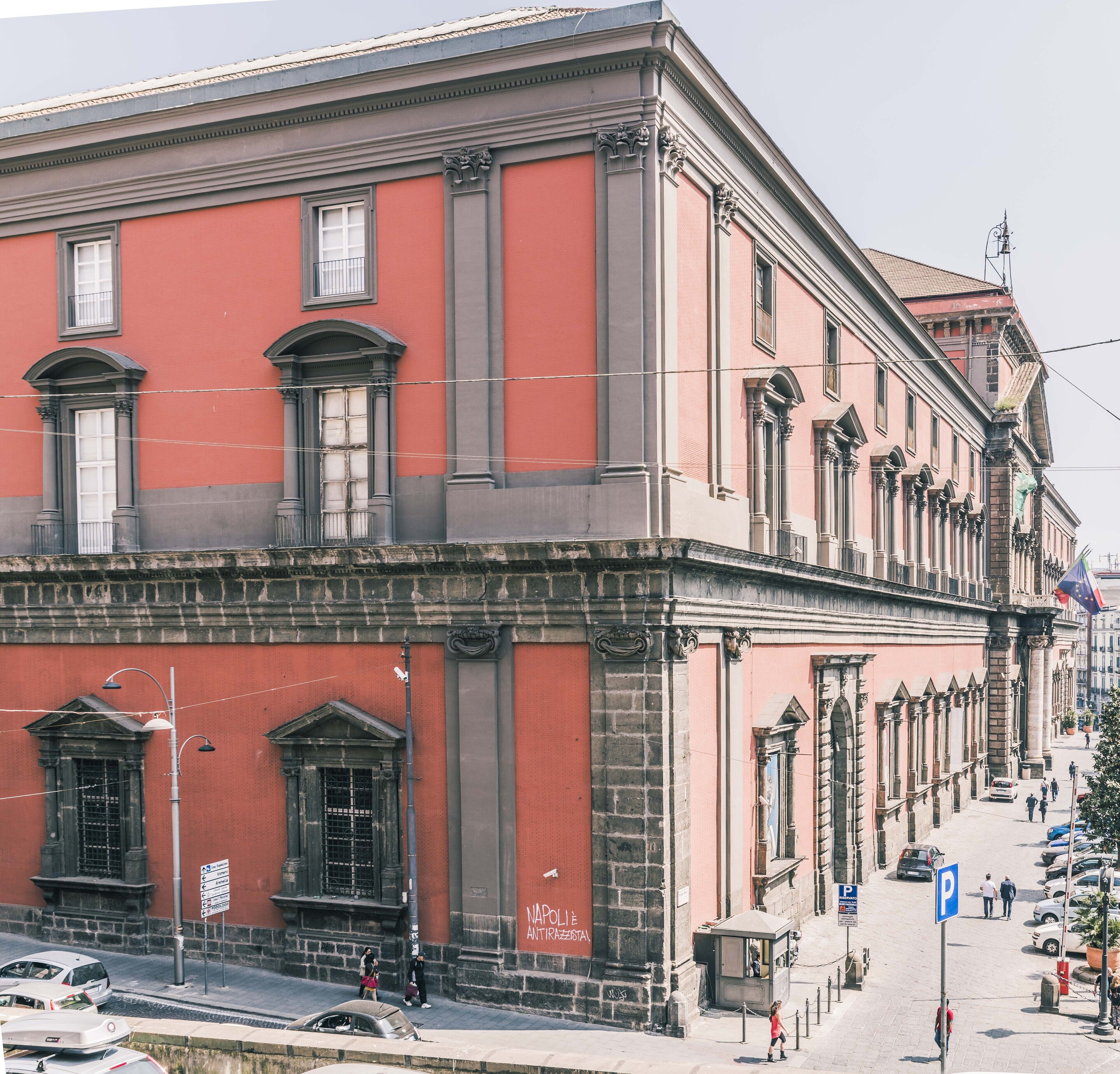 A historic building with classical architecture, featuring large windows and ornate columns.