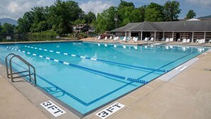 A swimming pool with lane dividers, a lifeguard chair, and lounge chairs. - Lone Star Retreat # 1-10 min to Waynesville & BR Pkwy-25 min to Biltmore Estate (Lake Junaluska)