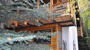 A wooden cabin with a balcony and a sign reading "3440 La Choumaine". - RMR: La Choumine 8 Condo in Teton Village / Steps from the Mountain! (Teton Village)
