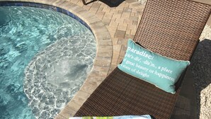 A pool area with a lounge chair and a towel with 'FLORIDA' written on it. -  Paradise Cove -- A perfect Beach Getaway (Bradenton)