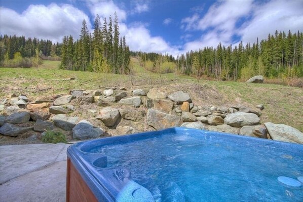 Relax in a serene hot tub surrounded by natural beauty.