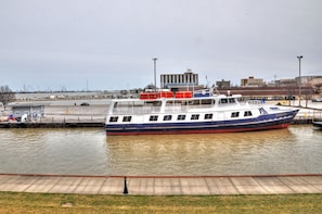 Docked at the marina, the GOODTIME boat offers a cabin and covered area for passengers.