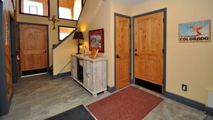 A wooden staircase with a lamp, a framed picture, and a sign on the wall. - Eagle's Ridge Lodge- 7 MIN WALK TO PEAK 9 & DOWNTOWN (Breckenridge)