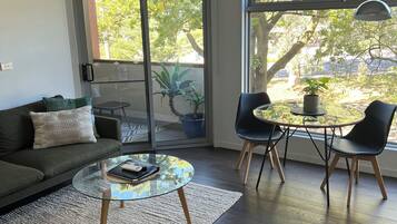 Deluxe Apartment, 1 Bedroom | Living area | Flat-screen TV