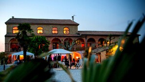 A large building with multiple arches and a tiled roof.