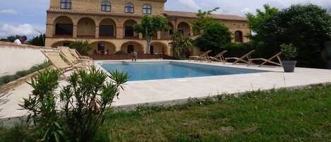 Seasonal outdoor pool, open 9 AM to 9 PM, pool umbrellas, pool loungers