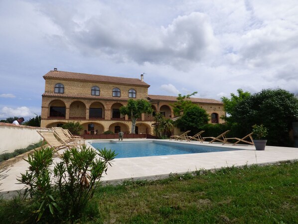 Seasonal outdoor pool, open 9 AM to 9 PM, pool umbrellas, pool loungers