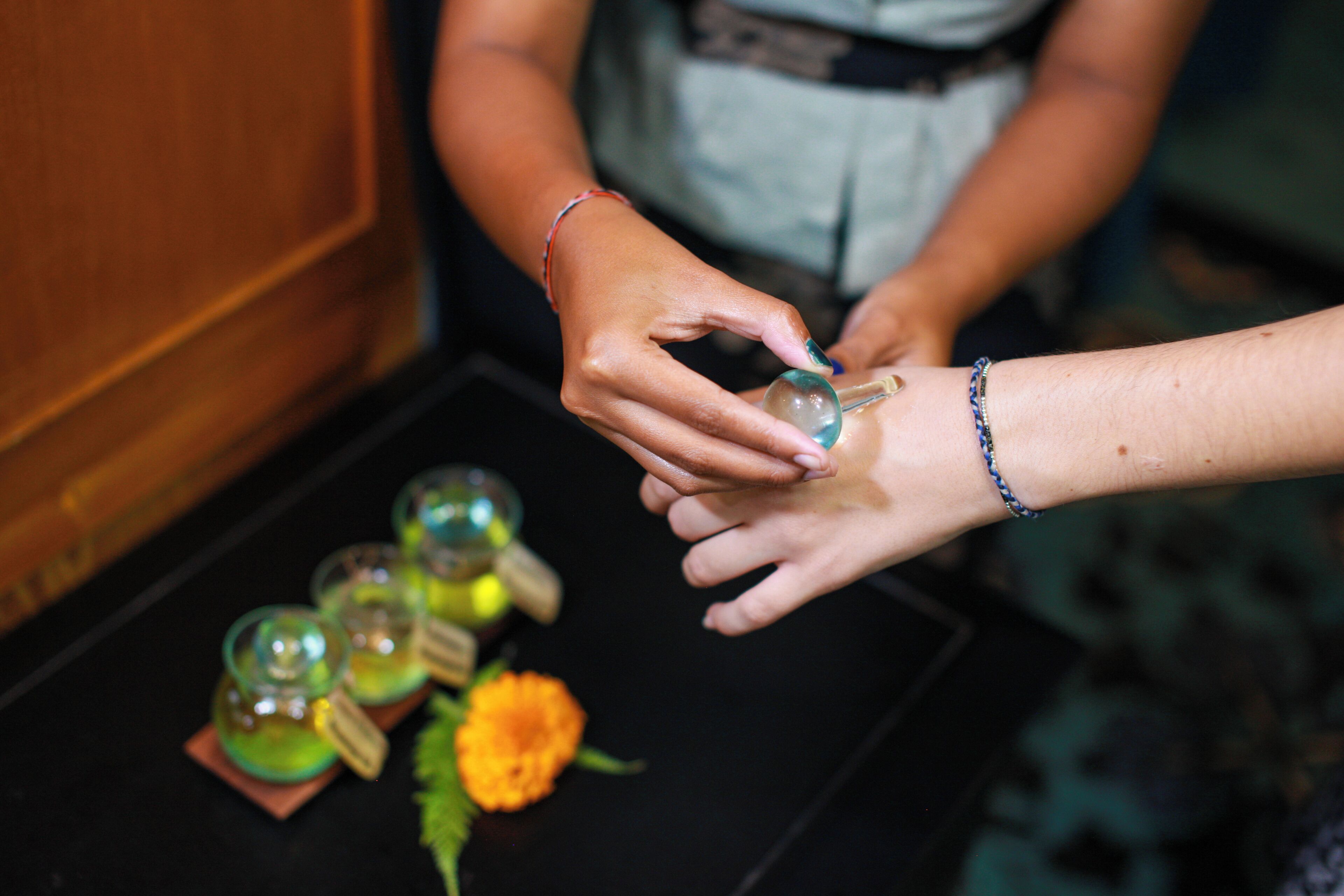 A person pouring a clear liquid into a glass.