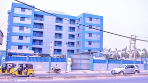 A multi-story building with balconies and a gated entrance. - Duban International Hotels (Lagos)