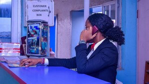 A customer complaints box and a counter with papers. - Duban International Hotels (Lagos)