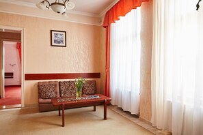 A living room with a sofa, a coffee table, and a picture on the wall. - Astoria Hotel (Balatonfured)