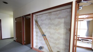 A hotel room with a sliding door, a bed, and a window. - Oyado Uchidaya (Nozawaonsen)