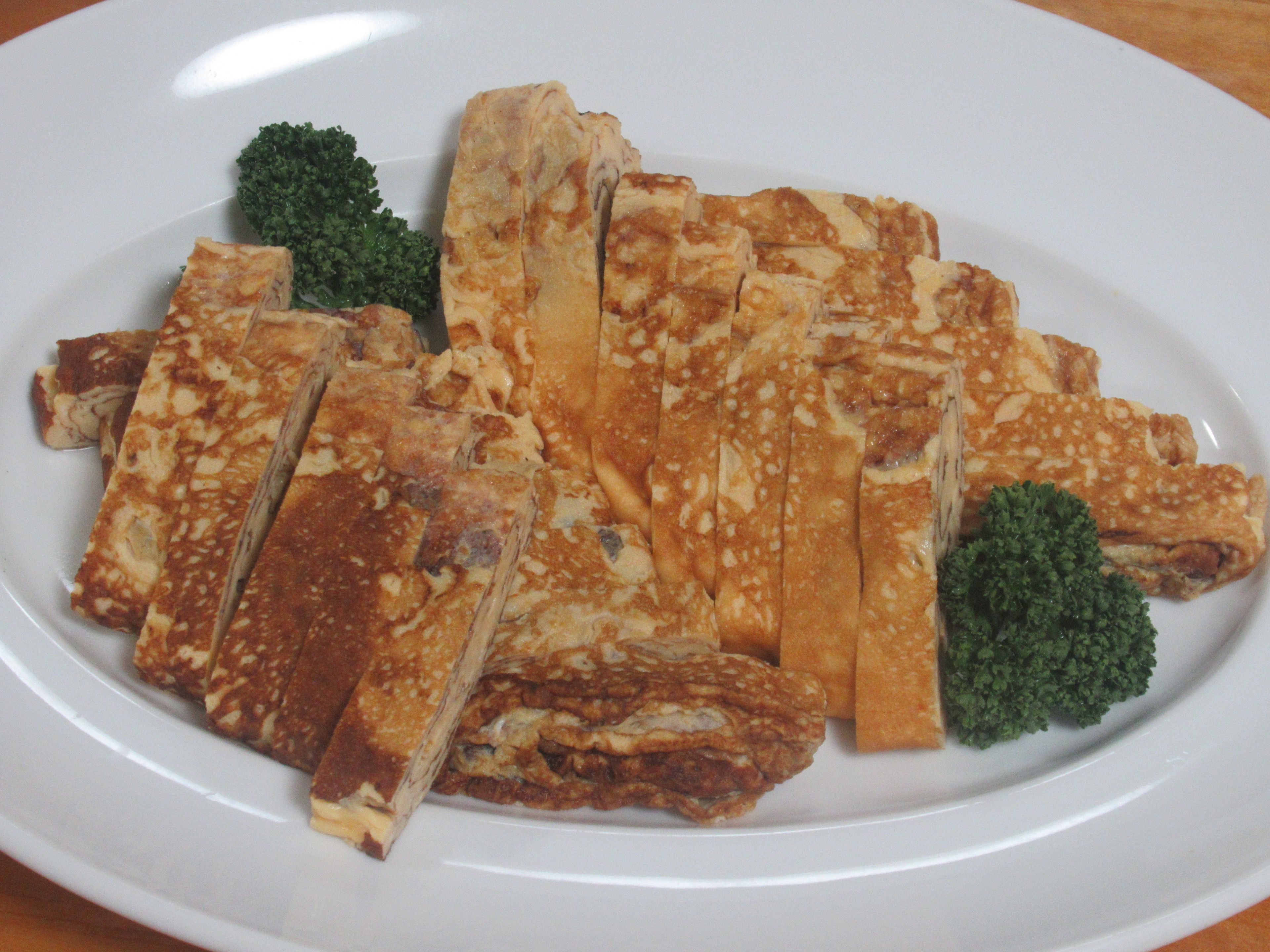 A plate of grilled cheese sandwiches with broccoli.