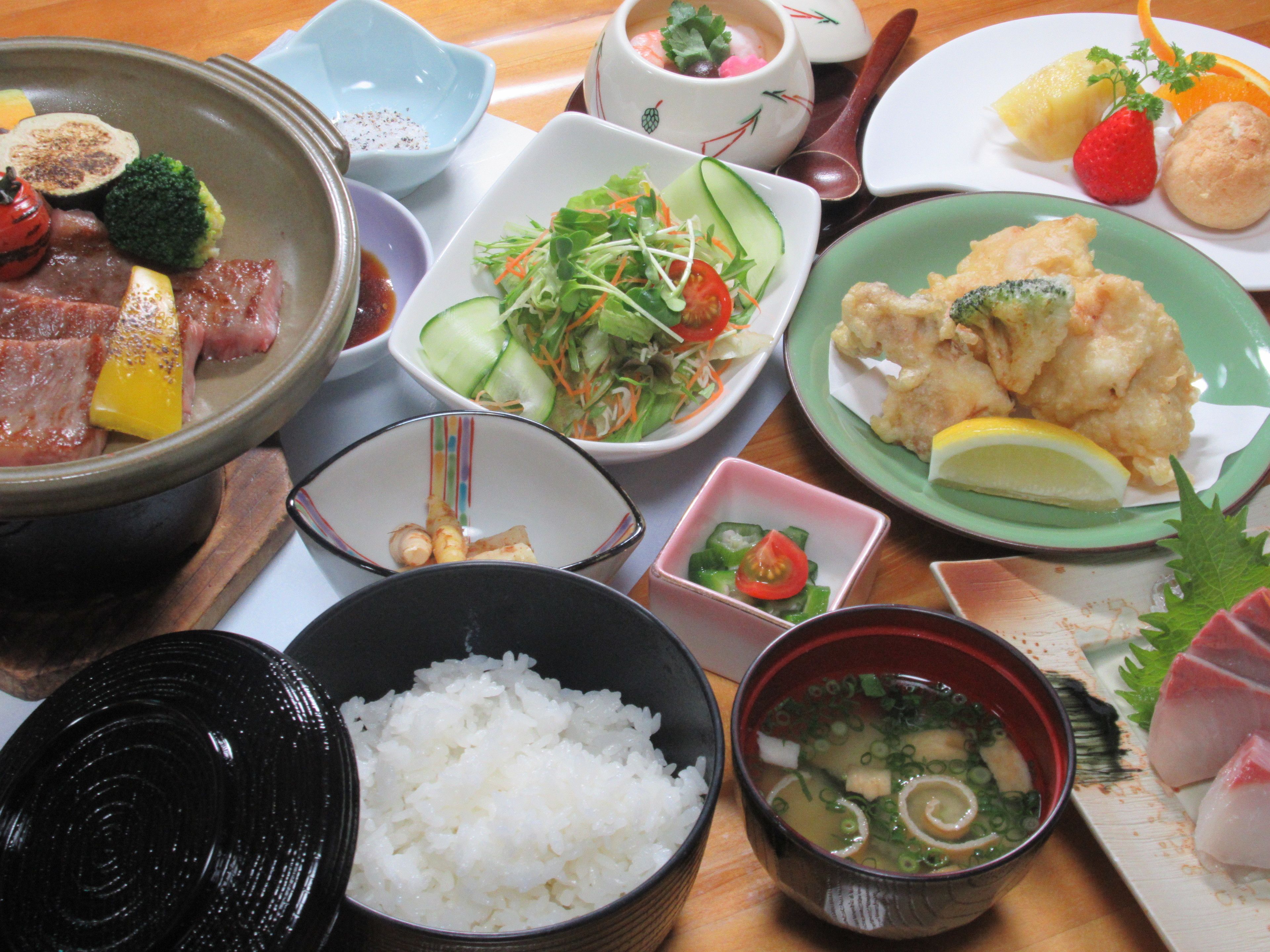 A variety of dishes including rice, soup, and vegetables.