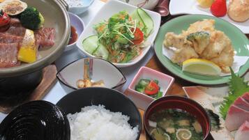 A variety of dishes including rice, soup, and vegetables.