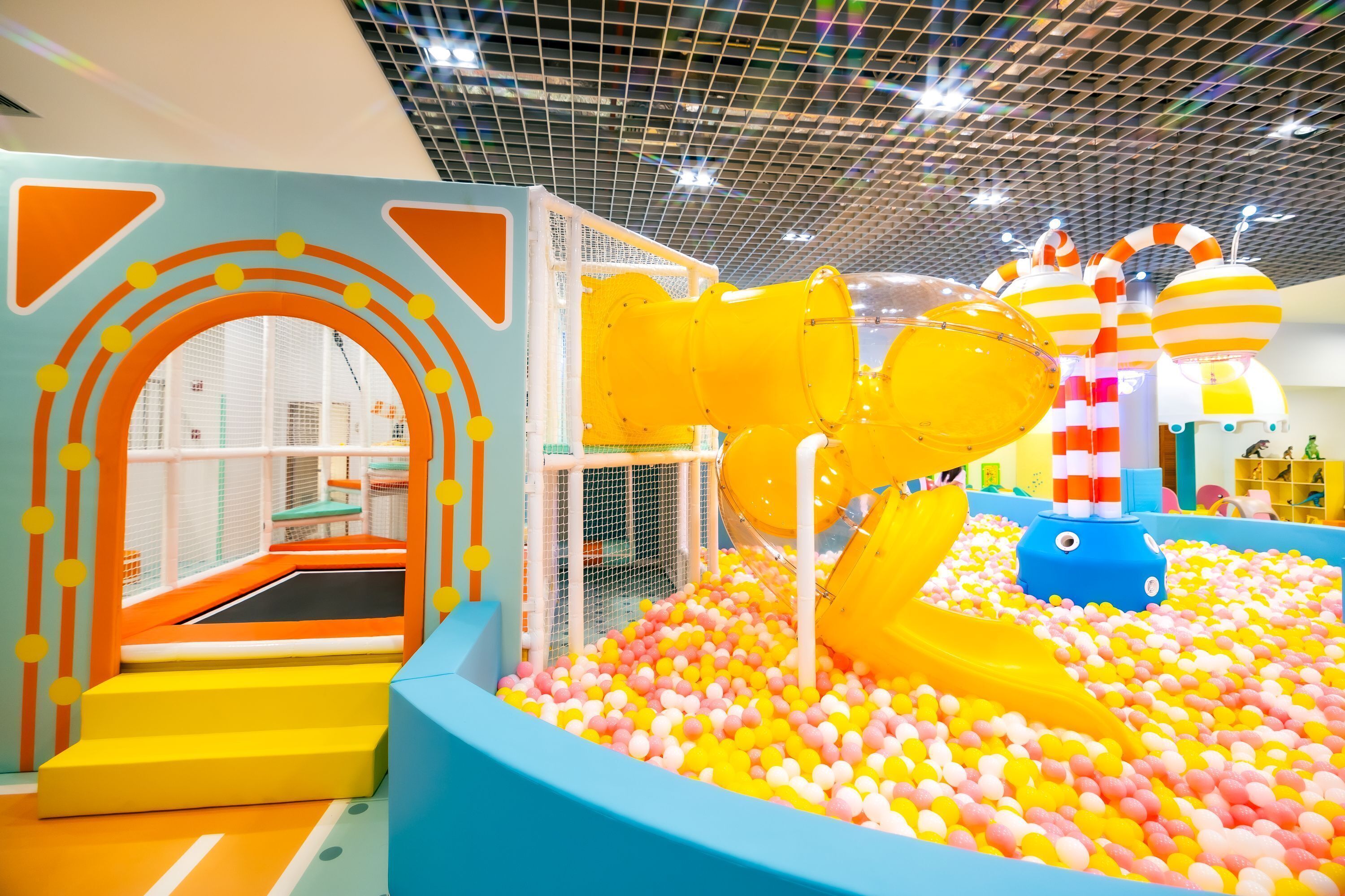 A children's play area with a ball pit, slides, and a climbing structure.