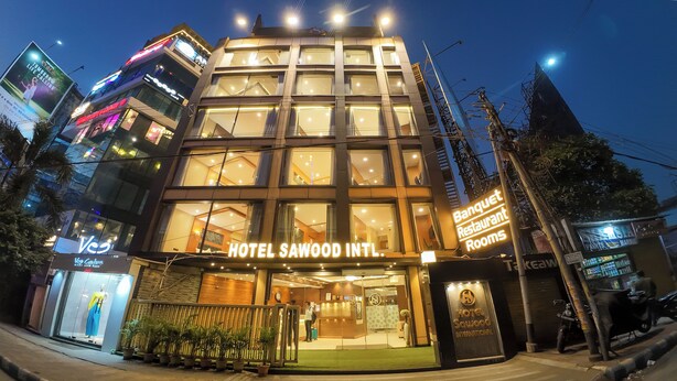 A hotel with a modern facade, large windows, and a sign indicating 'Banquet Restaurant Rooms'. - Hotel Sawood International (Kolkata)