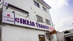 A building with a sign reading "BIKEJA TRANSIT HOTEL" and a smaller sign for "essential Budgethotels.com". - Ikeja Transit Hotel (Lagos)