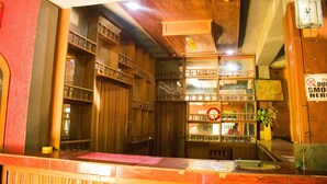 A bar area with wooden shelves and a no smoking sign. - Amenze Guest House (Lagos)