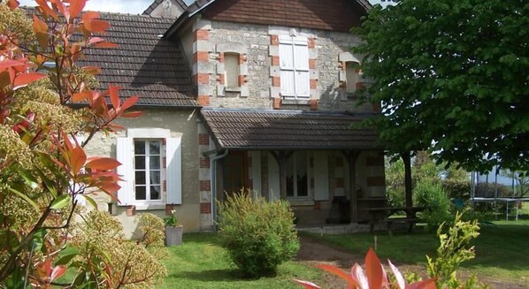 A two-story house with a stone facade, a tiled roof, and a covered porch. - Gîte en Forterre (Druyes-les-Belles-Fontaines)