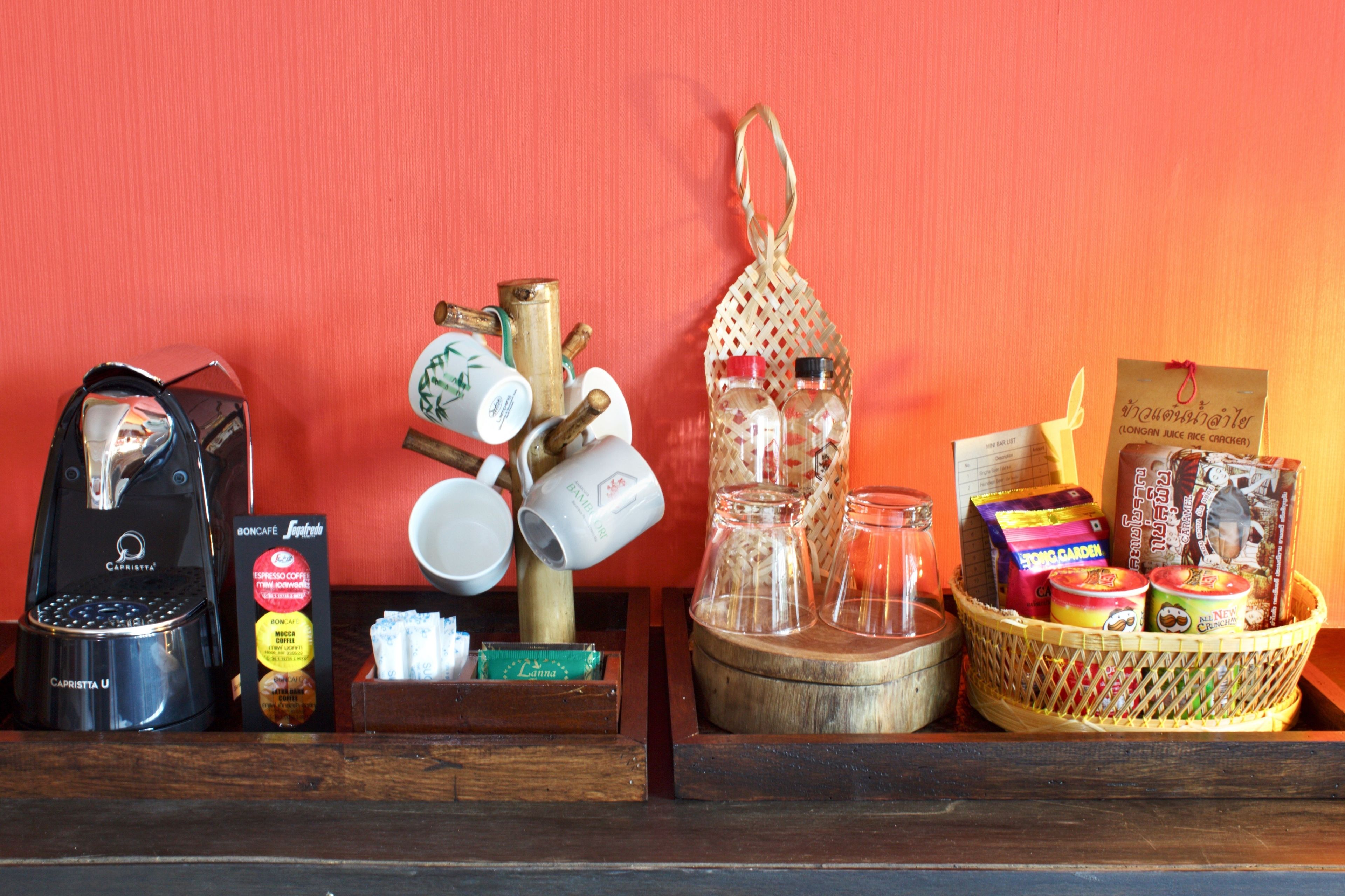 A display of various coffee and tea products, including a coffee machine, cups, and a basket of snacks.