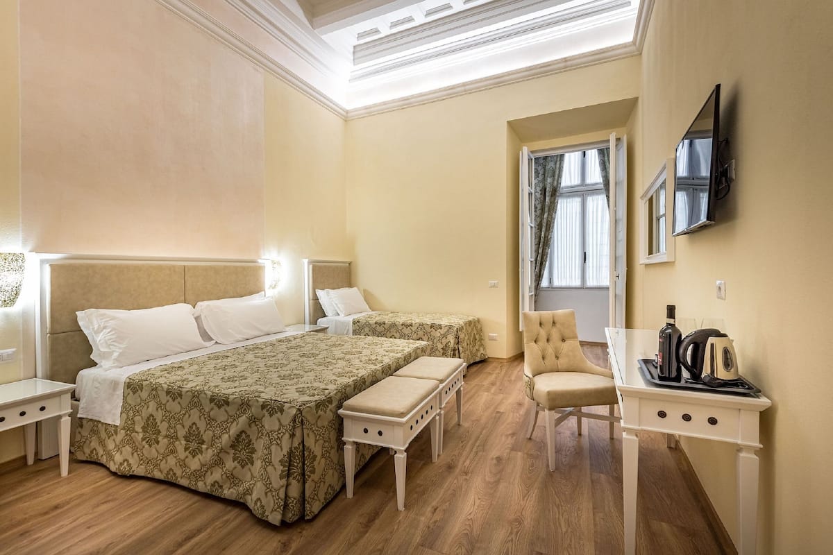 Family Room (Camera Deluxe Familiare) | Minibar, in-room safe, desk, laptop workspace