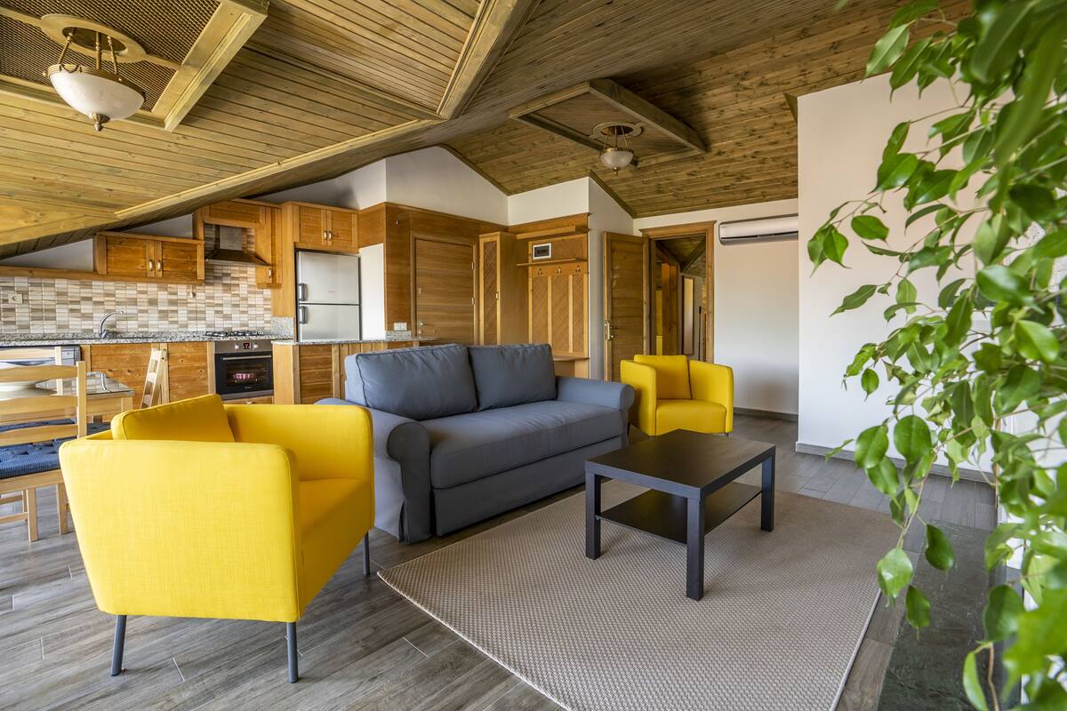 A modern living area with a sofa, armchairs, and a coffee table.