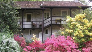 A two-story stone building with a balcony and a staircase. - Camping Valle Romantica (Cannobio)