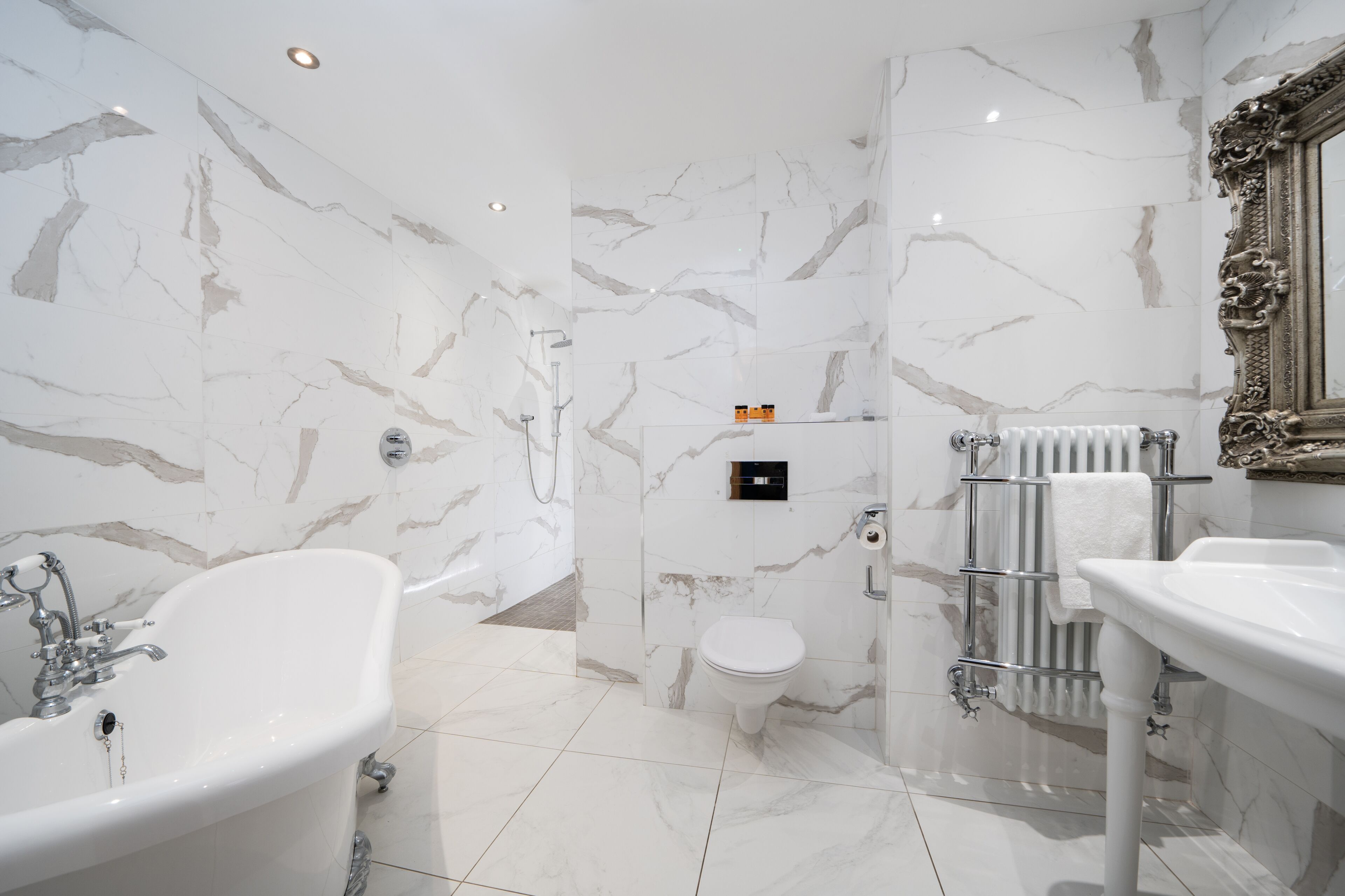 A bathroom with a freestanding bathtub, a toilet, and a sink.