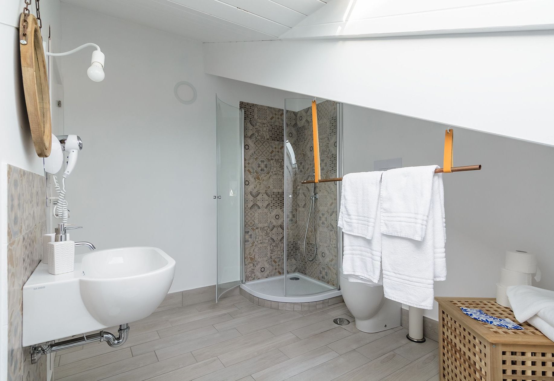 A modern bathroom with a freestanding sink, a glass shower enclosure, and a toilet.