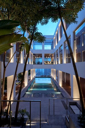 A modern building with a central pool, multiple floors, and surrounding greenery. - Alila Bangsar, Kuala Lumpur (Kuala Lumpur)