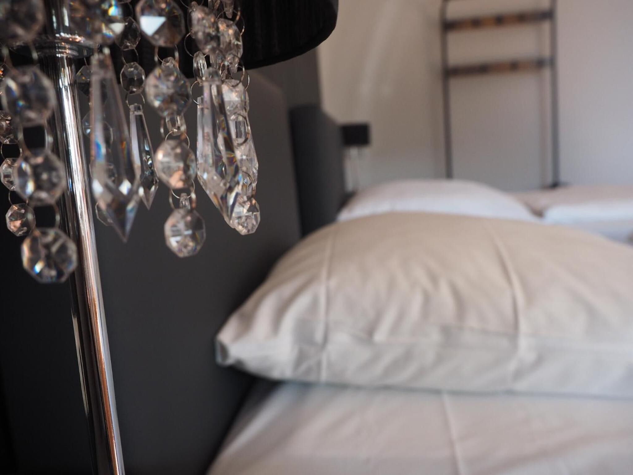 A close-up of a chandelier with multiple crystal elements.