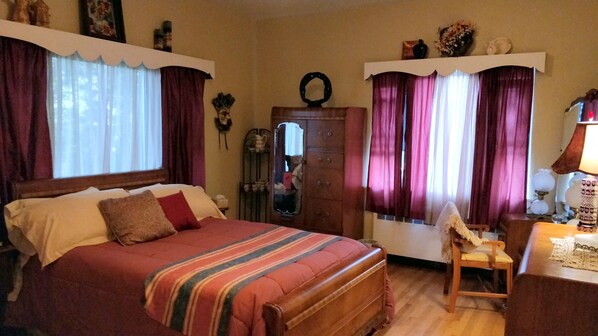 A bedroom with a large bed, a wooden dresser, a chair, and a desk with a lamp. - Maurrocks Bed & Breakfast (Mount Pocono)