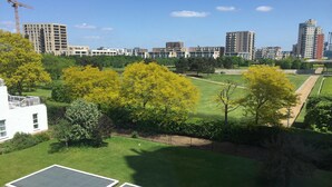 A residential area with modern buildings, green spaces, and solar panels. - Nice and private rooms (London)