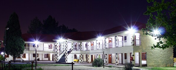 A multi-story building with a central staircase, balconies, and a courtyard.