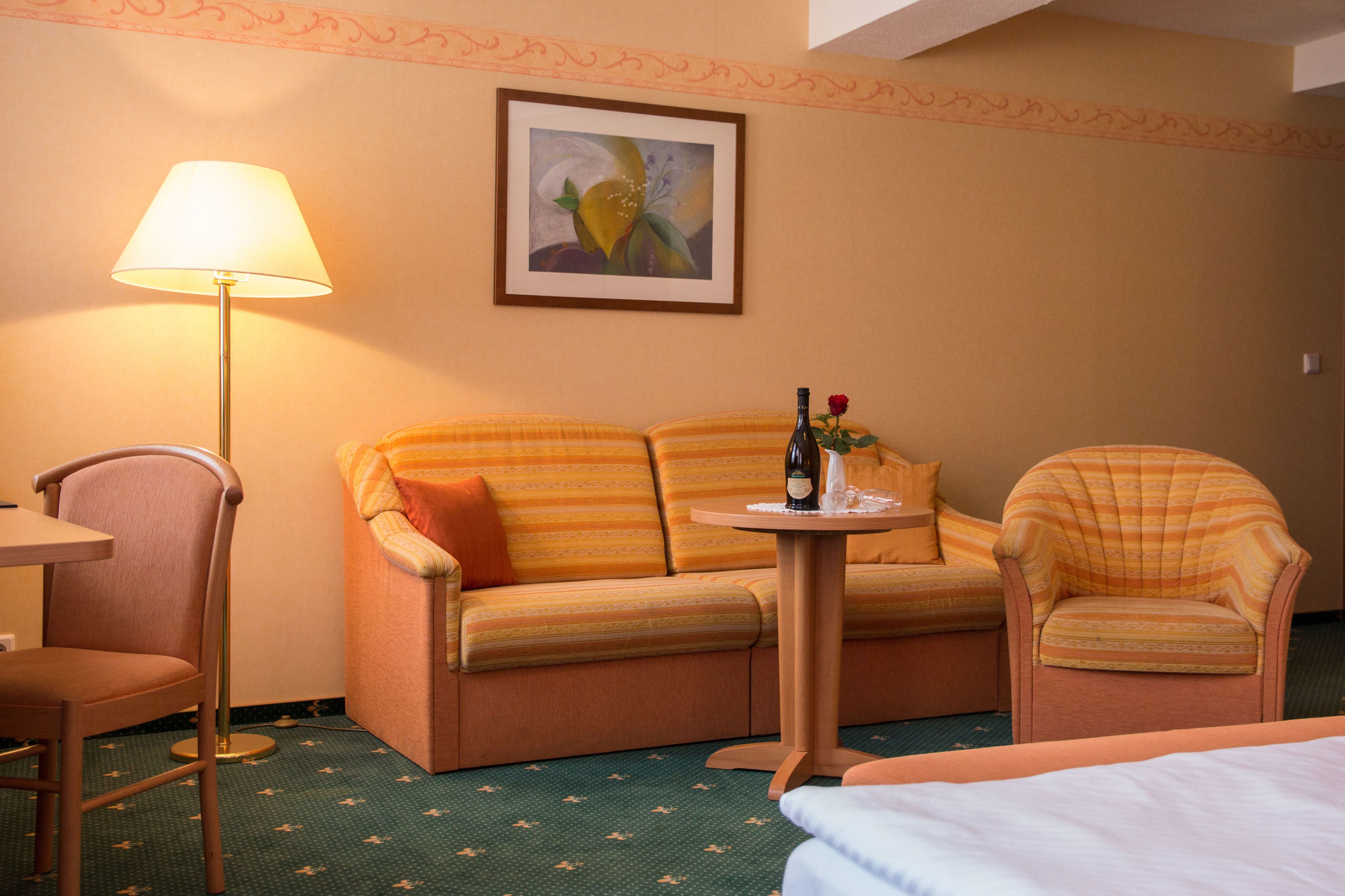 deluxe quadruple room | living area | flat-screen tv