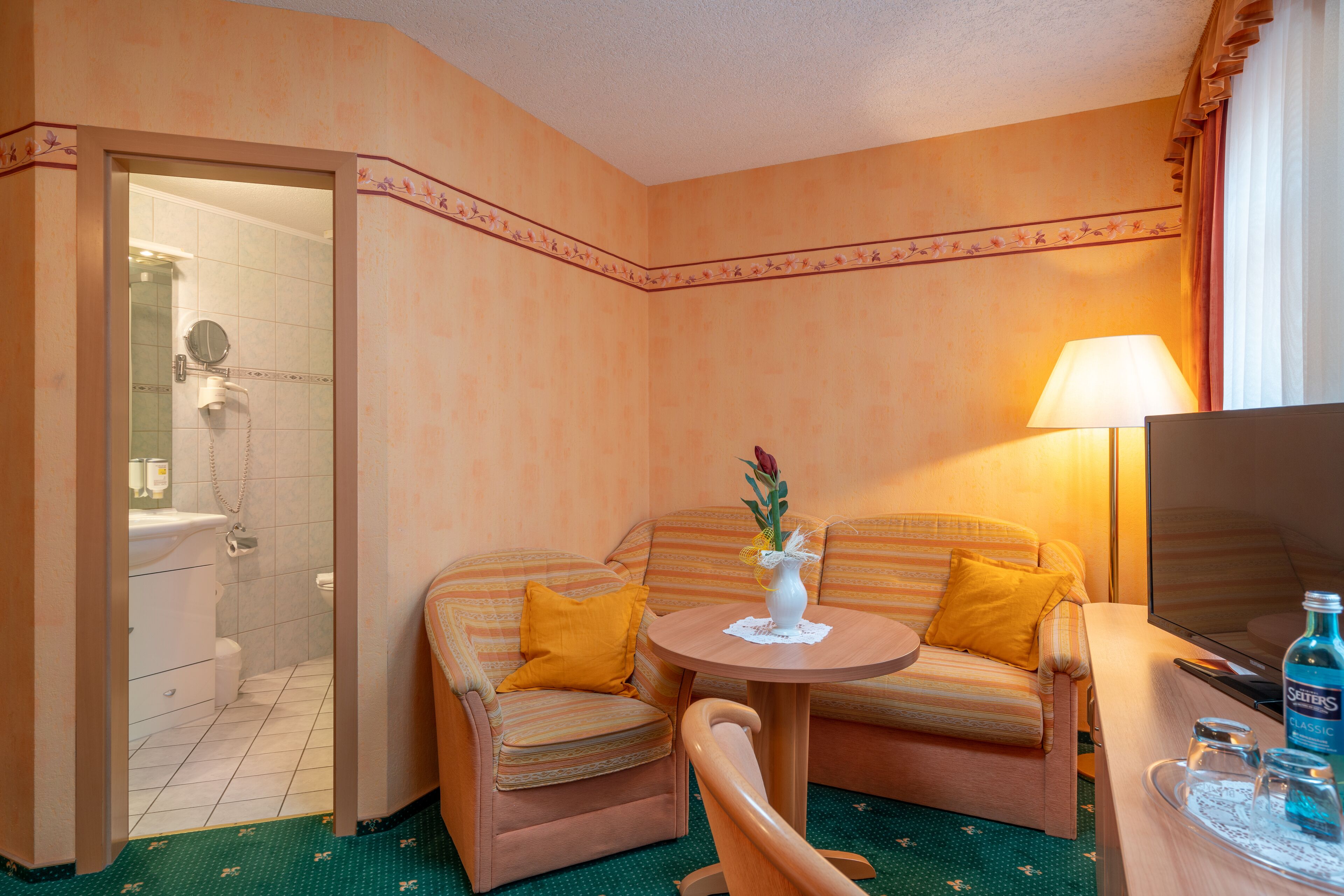 superior double room | living area | flat-screen tv