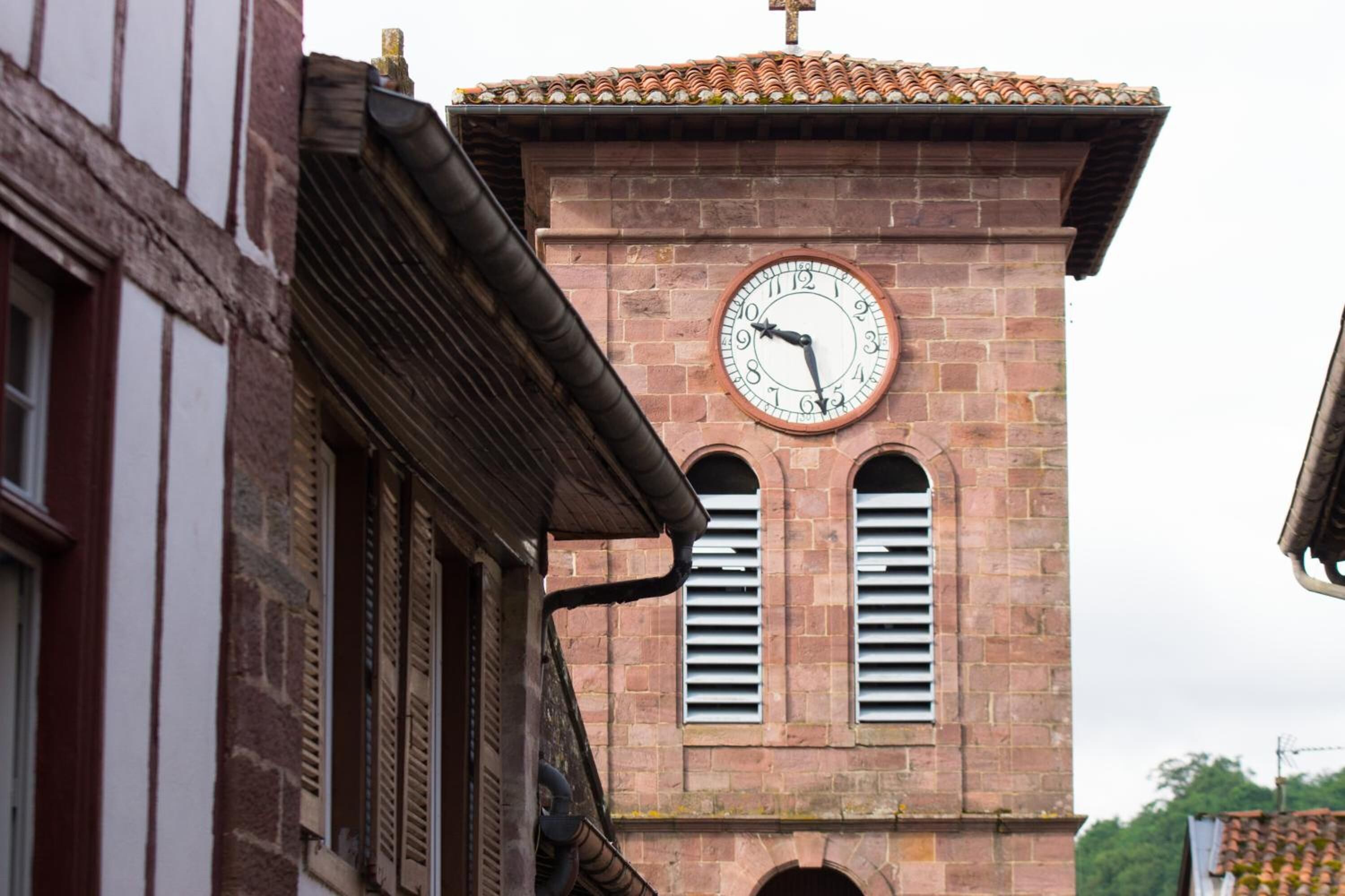 A clock tower with a brick facade and a traditional design.