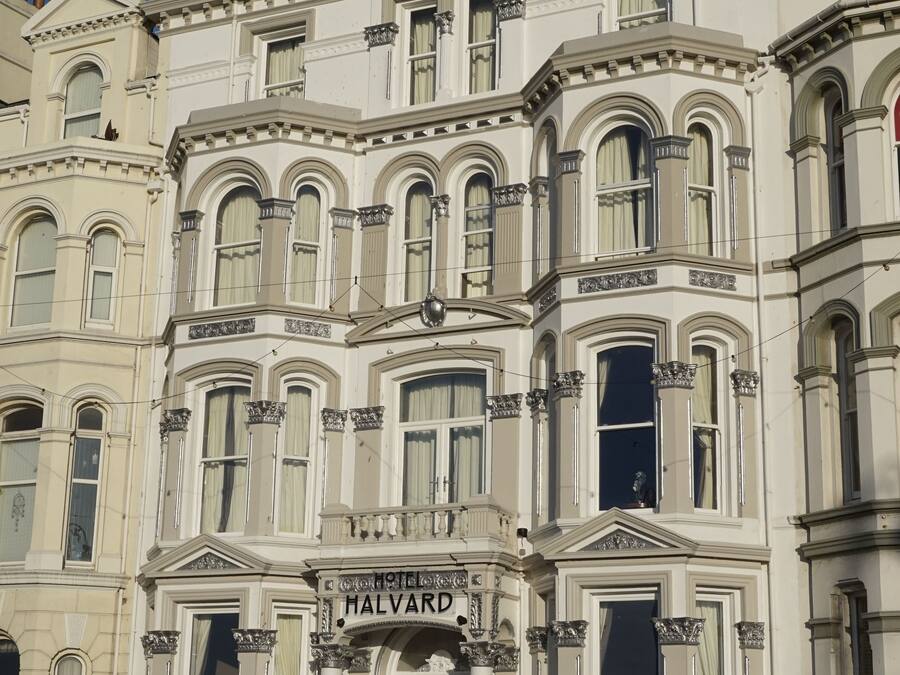 A historic building with a prominent 'HALVARD' sign, large windows, and classic architectural details.