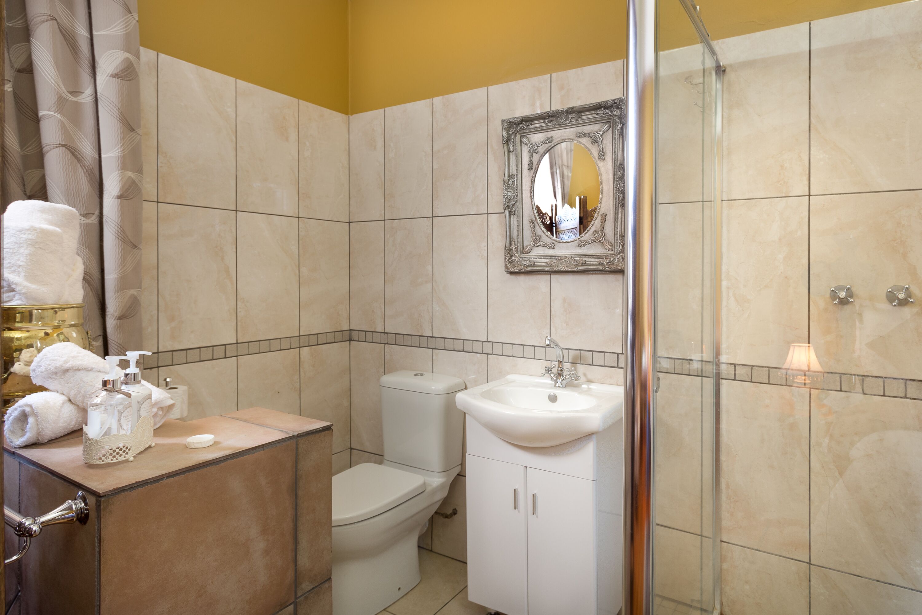 A bathroom with a toilet, sink, and shower.