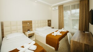 Family Room | Minibar, in-room safe, desk, cribs (free) - City Hotel (Batumi)