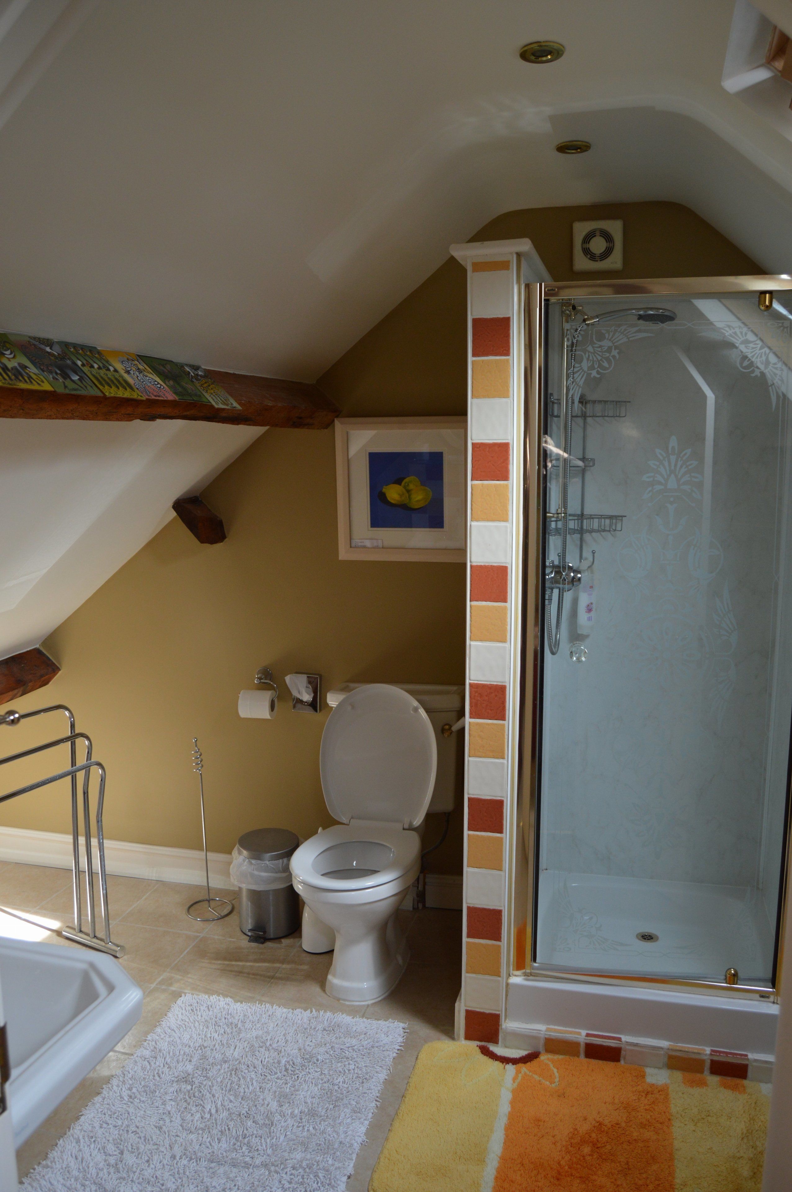 A bathroom with a shower, toilet, and bathtub.