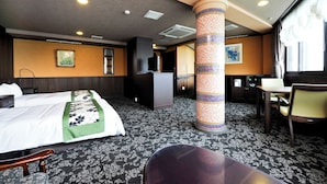 A hotel room with a bed, a desk, a chair, a minibar, a bathroom, and a view of the hallway. - Toshimaya Tsukihama-no-yu (Kitaibaraki)