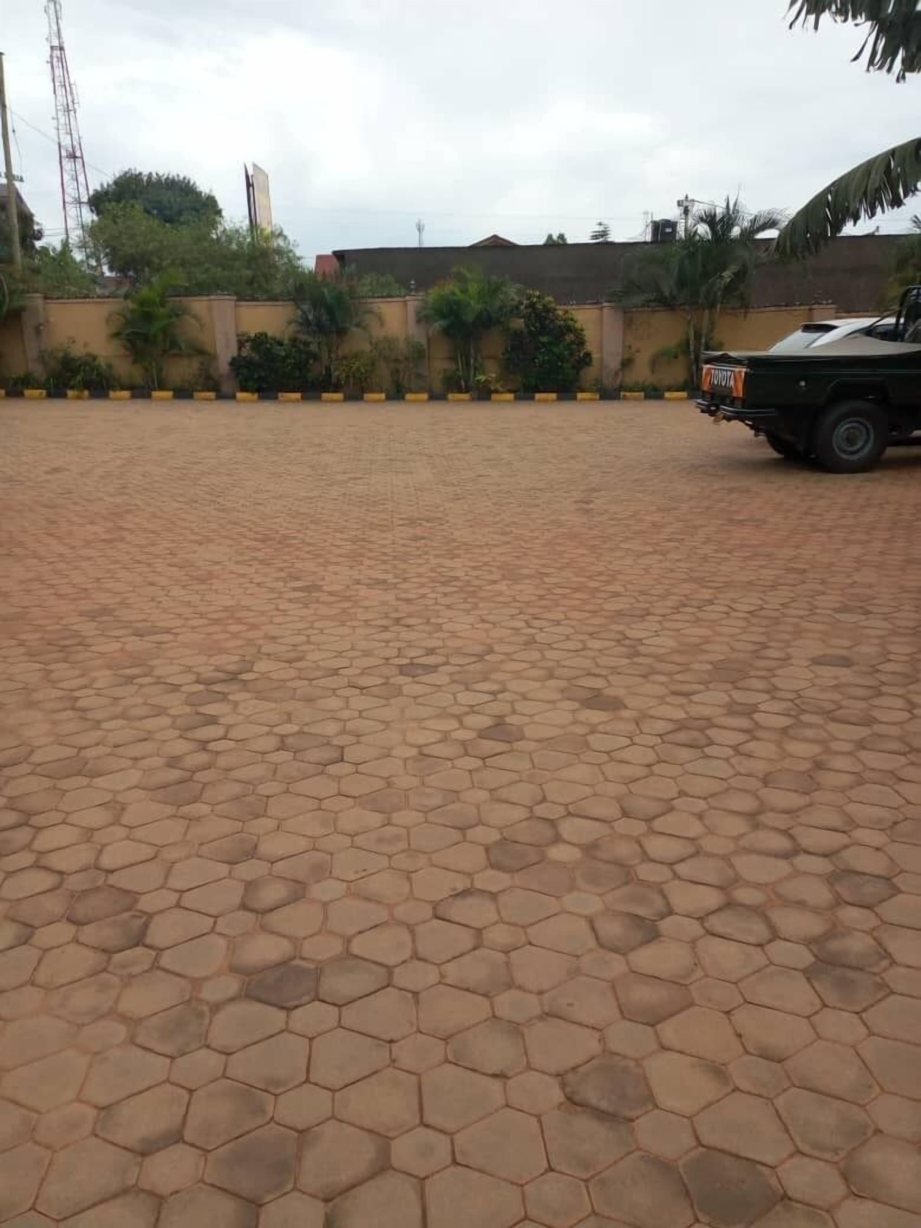 A paved outdoor area with a Toyota vehicle parked on the right.