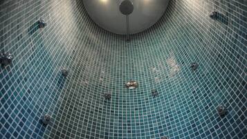 Experience the beauty of a circular ceiling with a radial pattern, featuring a central light fixture.