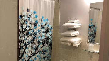 Combined shower/bathtub, deep-soaking bathtub, towels, soap