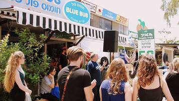 A busy outdoor market with various stalls and people.