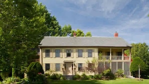A two-story house with a front porch, a chimney, and a well-maintained lawn. - The Waterford Inne (Waterford)