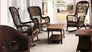 A covered porch with wicker furniture, large windows, and a view of the outdoors. - Franklin Terrace Bed and Breakfast (Franklin)